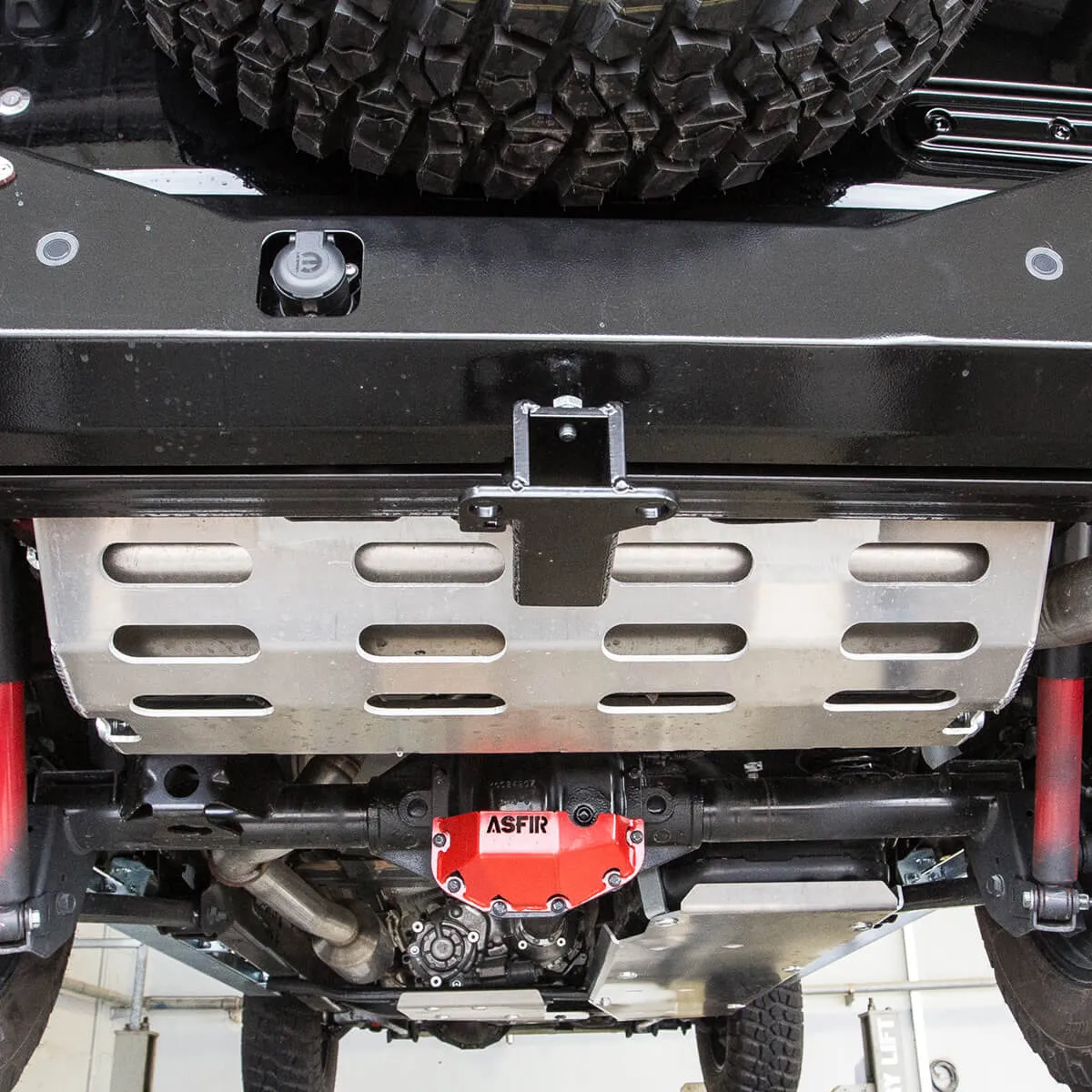 ASFIR skid plate and red differential guard under a Subaru