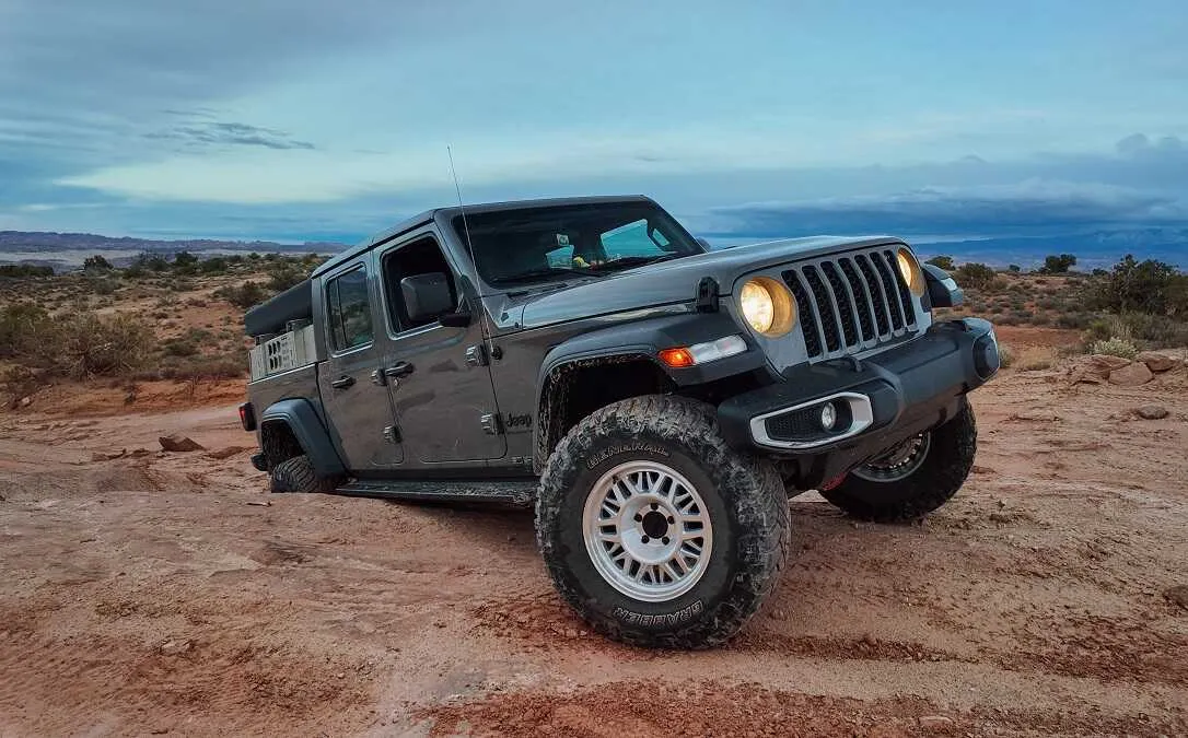 Off-roader with ASFIR rock sliders on a red dirt trail