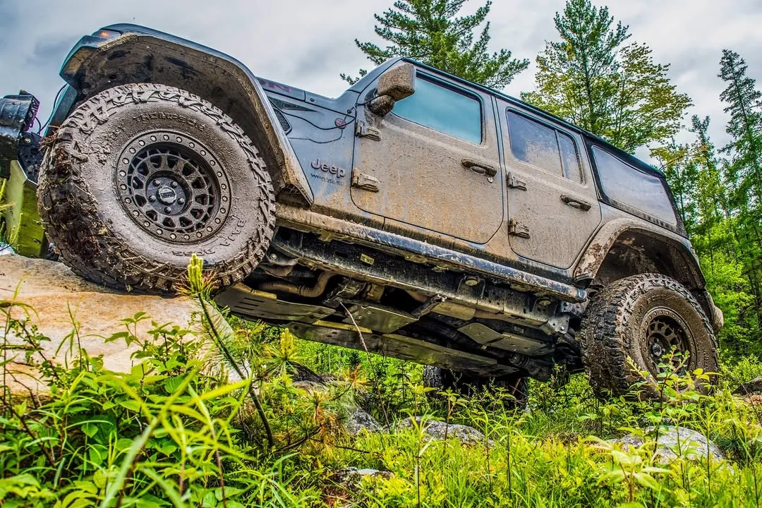 4x4 climbing a ledge in the forest